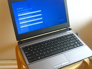An opened laptop sitting on a chair, with a blue dialog screen showing.