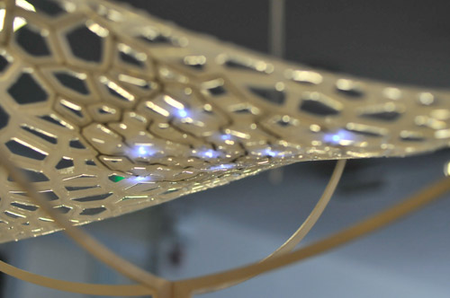 Close-up photo of the assembled lamp, showing detail of the silicone, fabric, and illuminated SMDs.